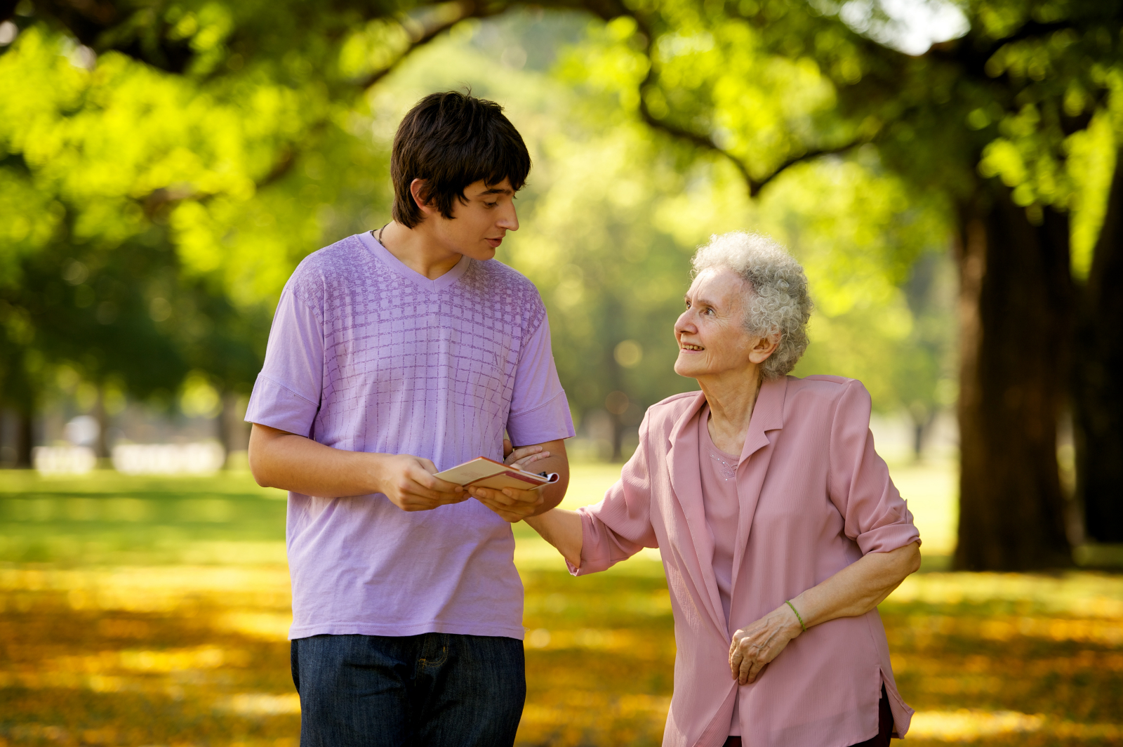 a carer walking with an elderly patient