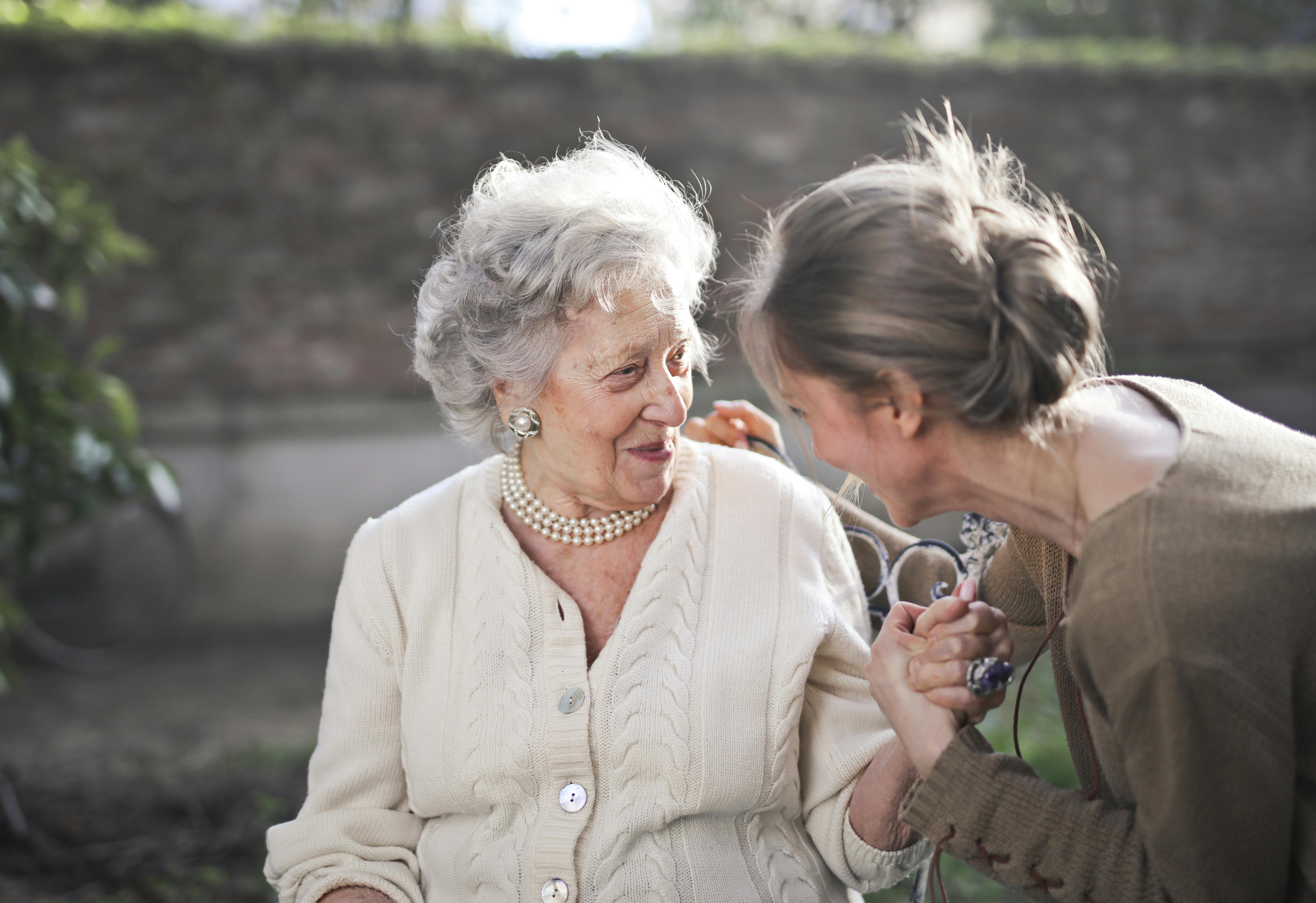 two women holding hands and smiling